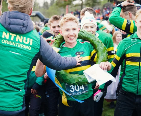 Bildtext toppbild: En lycklig Eirik Langedal Breivik med hela NTNUI bakom sig. Till höger svenske Albin Warvelin som sprang andra sträckan.